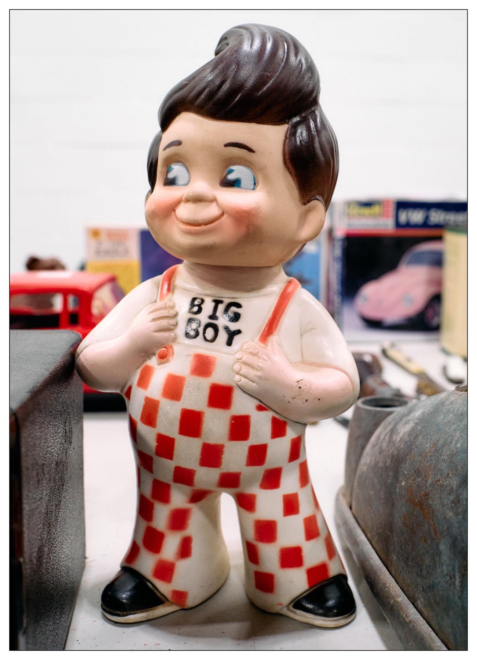 Vintage doll or mascot for "Big Boy" restaurants. It is a round boy in red and white checkered overalls with the words big boy on his shirt. Kinda looks like a kewpie doll. Feels 1930s or 1940s to me.